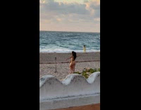 Two women bikini dances at the beach