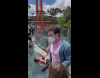 Woman in tube top lie down on the glass bridge