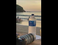 Three girls sit knee up beach sunset