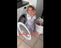 Little girl helps to do their laundry