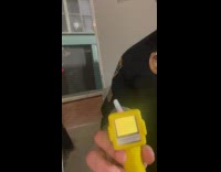 Woman test breathalyzer with cop