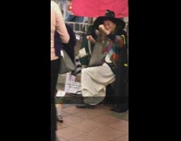 Lady black witch hat plays metal instrument