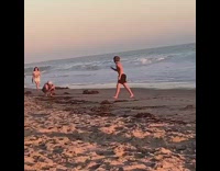 Man shirtless back flip beach sunset shoot