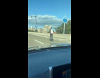 Man rides the scooter on the parkway