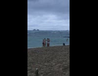 Four girls dance beach shore black backpack