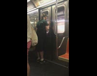 Guy green shirt pony tail staring at subway door