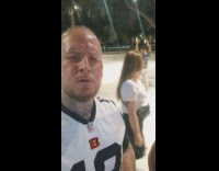 Man films man raises hands at park