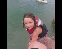 Girl jumps off cliff into ocean below 
