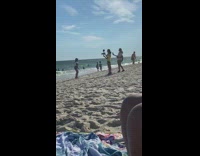 Woman blue hat jumper red shoes dance beach