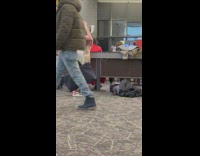 Girl beanie grey pants dance in airport