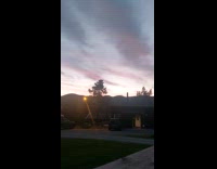Time lapse sunset clouds move lamp pole activates