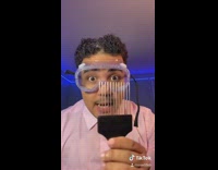 Pink shirt guy runs comb through hair 