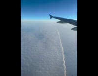 Plane view over edge of clouds