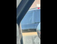 Man holds his dog along the street in the morning