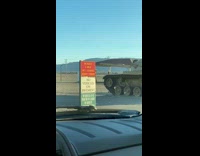 Guy poses on army tank for photo 