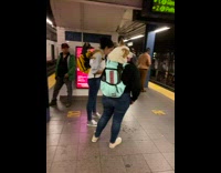 2 dogs in backpacks at subway 