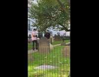 Woman in black dress outfit tiktok dance at the graveyard