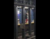 Guy red pants dances on the phone in subway station