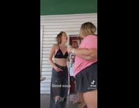 Ladies spit their drinks into each others mouth 