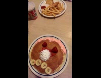 Boy shows sad pancake face on plate