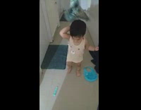 Kid suddenly hits camera person with feather duster