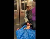 Man in train with woman cardboard cutout