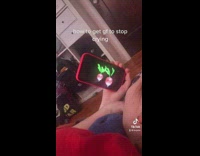 Girl watching two dancing turnips on phone 