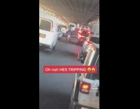 Scooter drives inside bridge with cars 