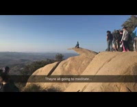 Line of People Wait for Woman to Finish Meditating for Photo