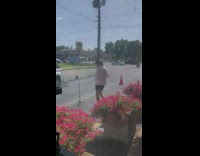 woman selfie stick between flower pots