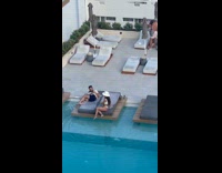 Man takes photo of woman in white bikini on the sunbed