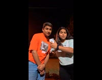 Boy and girl pose dance to music