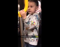 Little boy cartoon sweatshirt  licks yellow handle bar on subway train