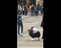 Woman in blue outfit flexes butt in the middle of the park