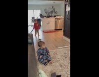 Little boy hits little girl on head with plastic blue bat 