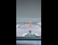 Man orange hoodie tiktok dance at park