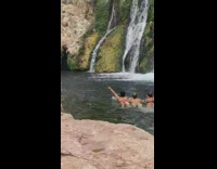 Guy photographs three girls waterfall pool noodle 