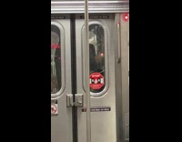 Person using lighter in between subway trains