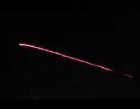 Rapid red bullets lights shoot out sky 