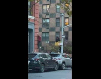 Guy scaling down a brick building