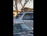 Two women tiktok dance on the sidewalk