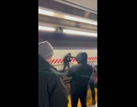 People curse at man on train tracks