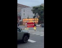 Two guys carry McDonalds sign on street part 2