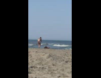 Black bathing suit girl crawls beach sand 