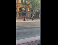 Woman in red top sits in the middle of the main street