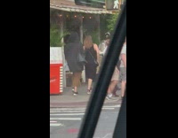 Lady carries duck in her transparent backpack on street 