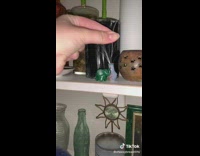 Girl puts white whiskers from cats into vase