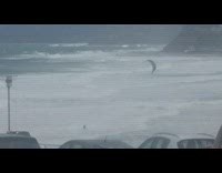 Man kite surfs on a bad weather at the beach