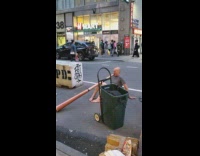 Guy sits in street and plays instrument