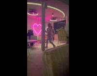 Two women dances on corner of bar